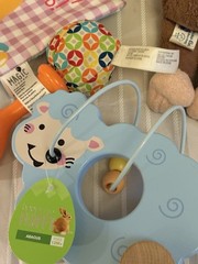 collection of infant clothing and toys, including branded
